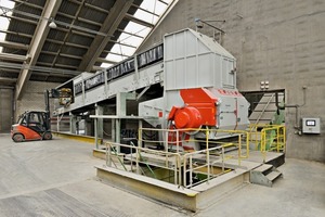 2 Feeding the unwashed paper sacks to the shredder