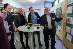 3 Prof. Pöllmann (right) in discussion with some of his students about the poster session