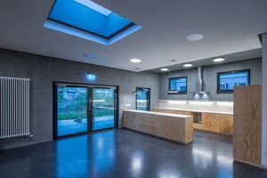 Like the house, the plywood kitchen – which is located in the middle of the youth club and family centre – is also customised